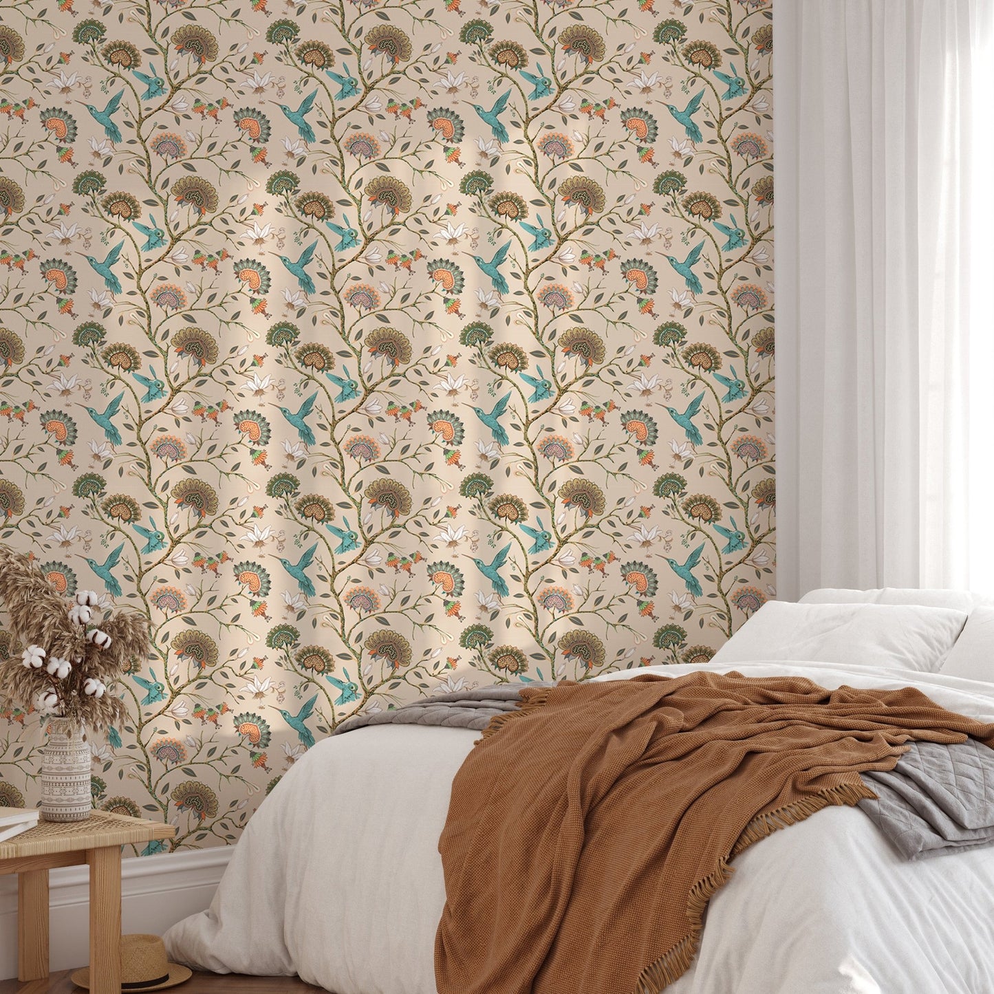 Botanical flower wallpaper behind a white bed with blue and beige linens.