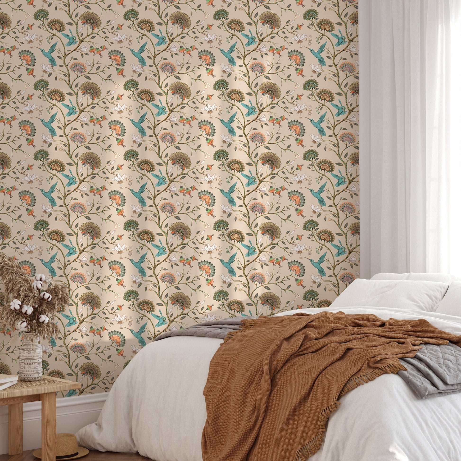 Botanical flower wallpaper behind a white bed with blue and beige linens.