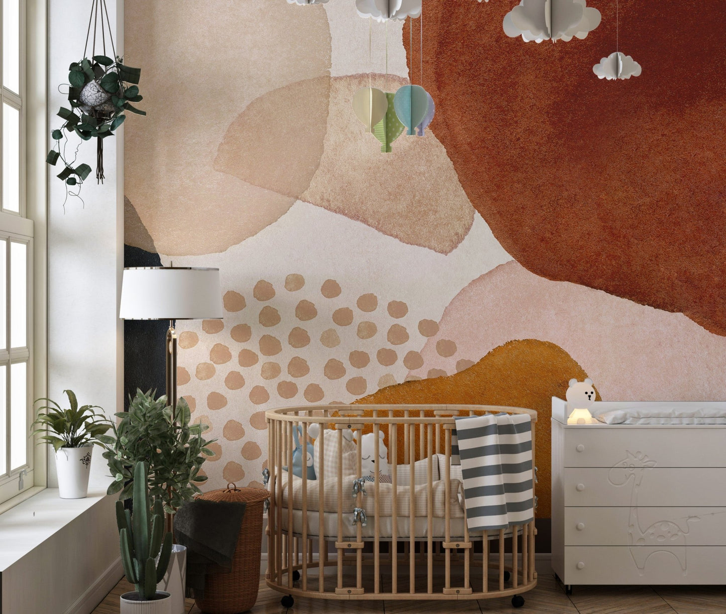 Nursery with a wooden crib and terracotta abstract watercolor melody wall mural.
