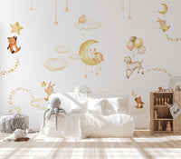 Dreamy sky scene wall mural with hanging gold ornaments.