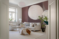 Living room featuring a large white circle and mauve shape on a wall mural.