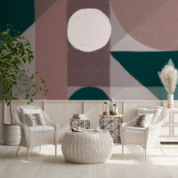 White wicker chairs in front of a Terra Shapes Wall Mural with geometric patterns.