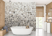 Modern bathroom with white tub and a grey marble tile wall mural design.