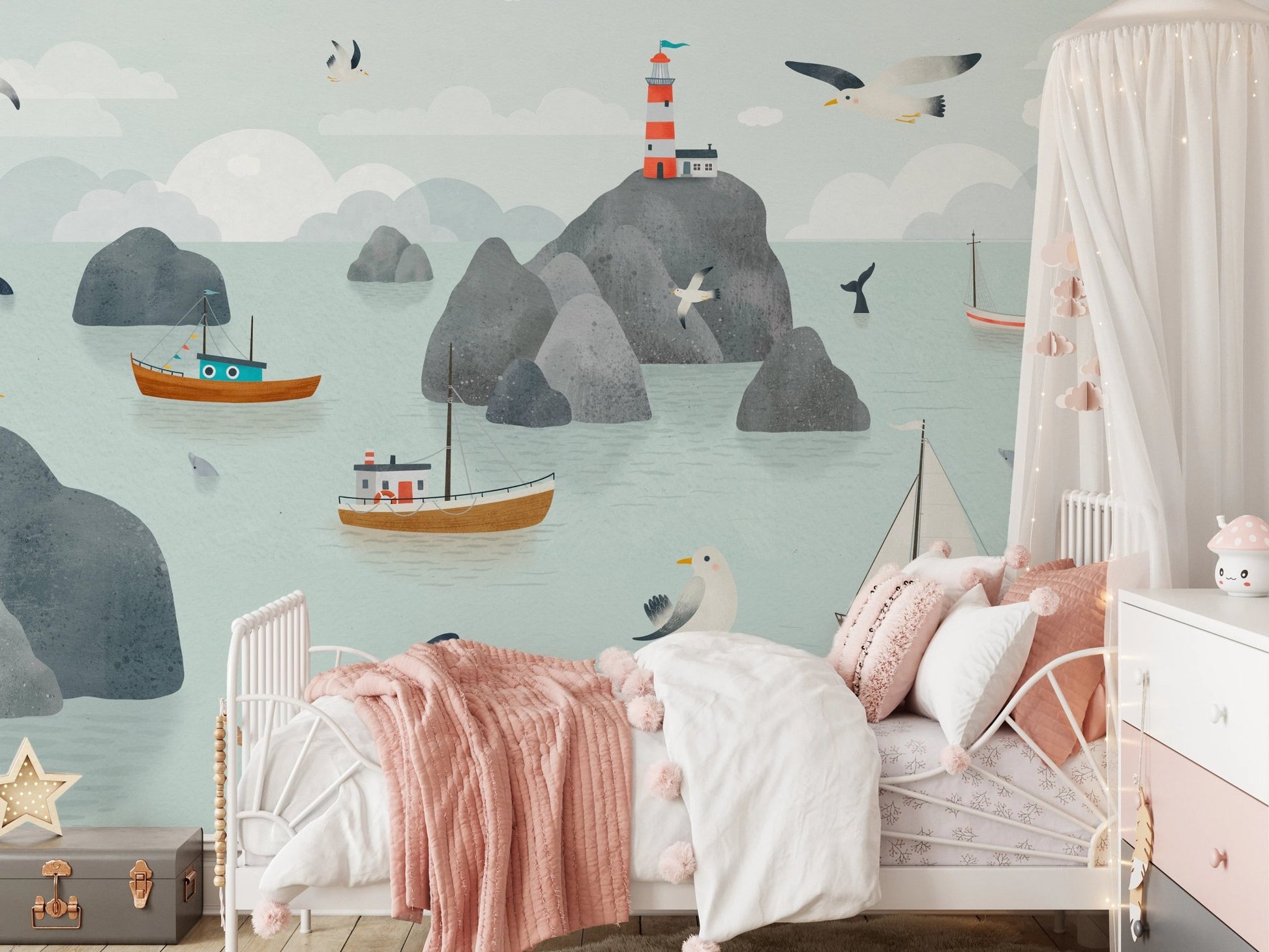Kids bedroom featuring a seaside wall mural with lighthouse and mountain illustrations.