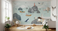 Coastal stories wall mural with boat motifs in a bright room with white curtains.
