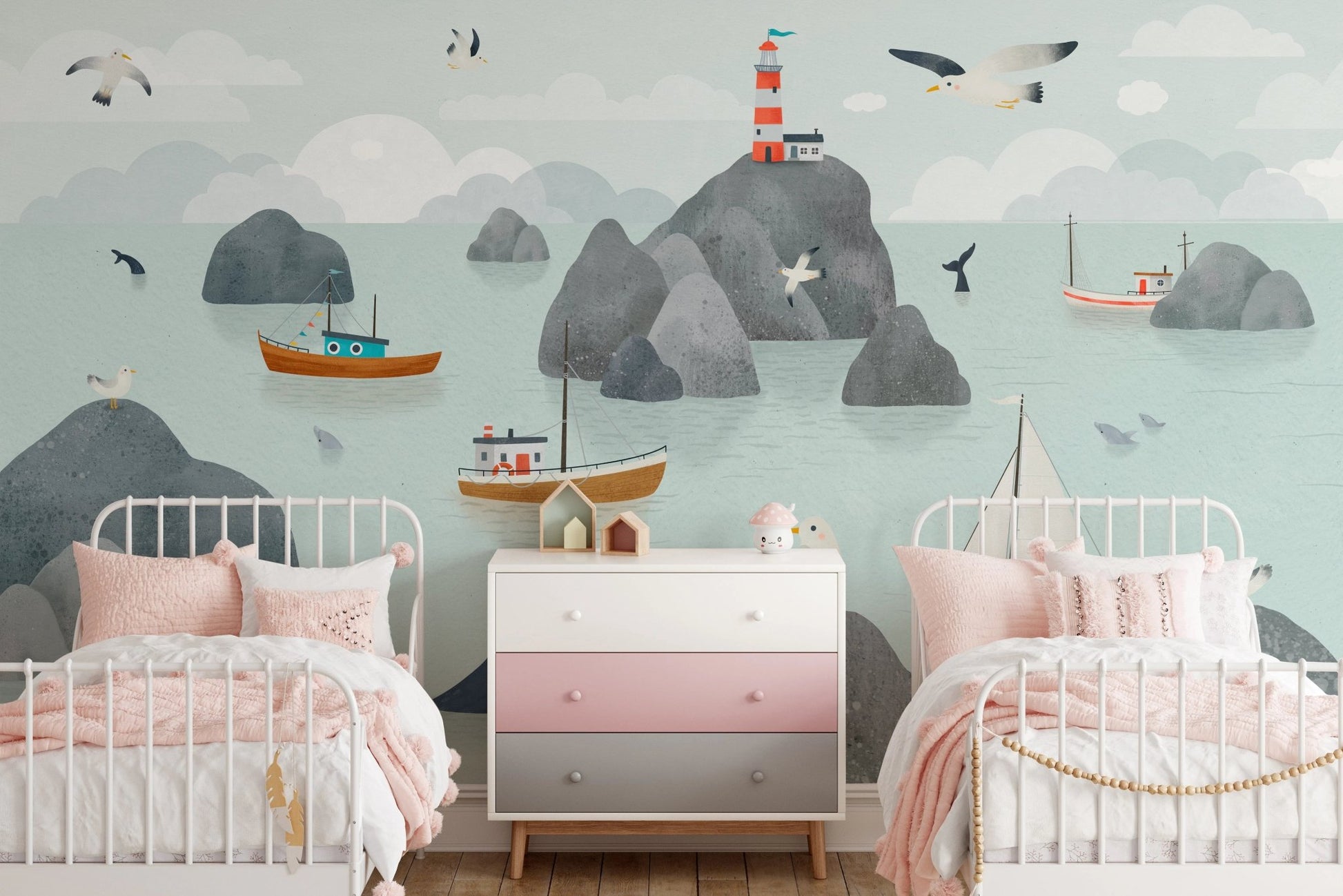 Nautical seaside wall mural behind a twin bed with pink and white bedding.
