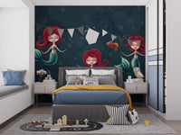 Three Underwater Mermaids Wall Mural in a kids bedroom with grey bed and bunting.