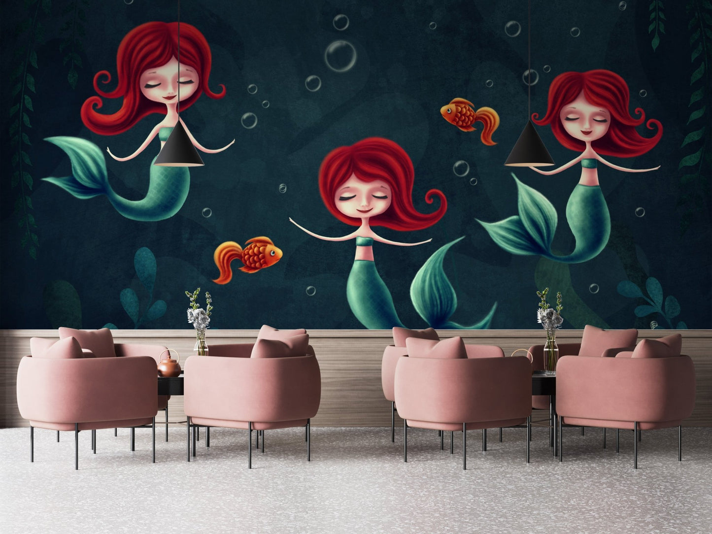 Three red haired mermaids wall mural behind pink velvet chairs in a open room.