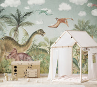 Dinosaur era wall mural behind a white play tent and wooden toy chest.