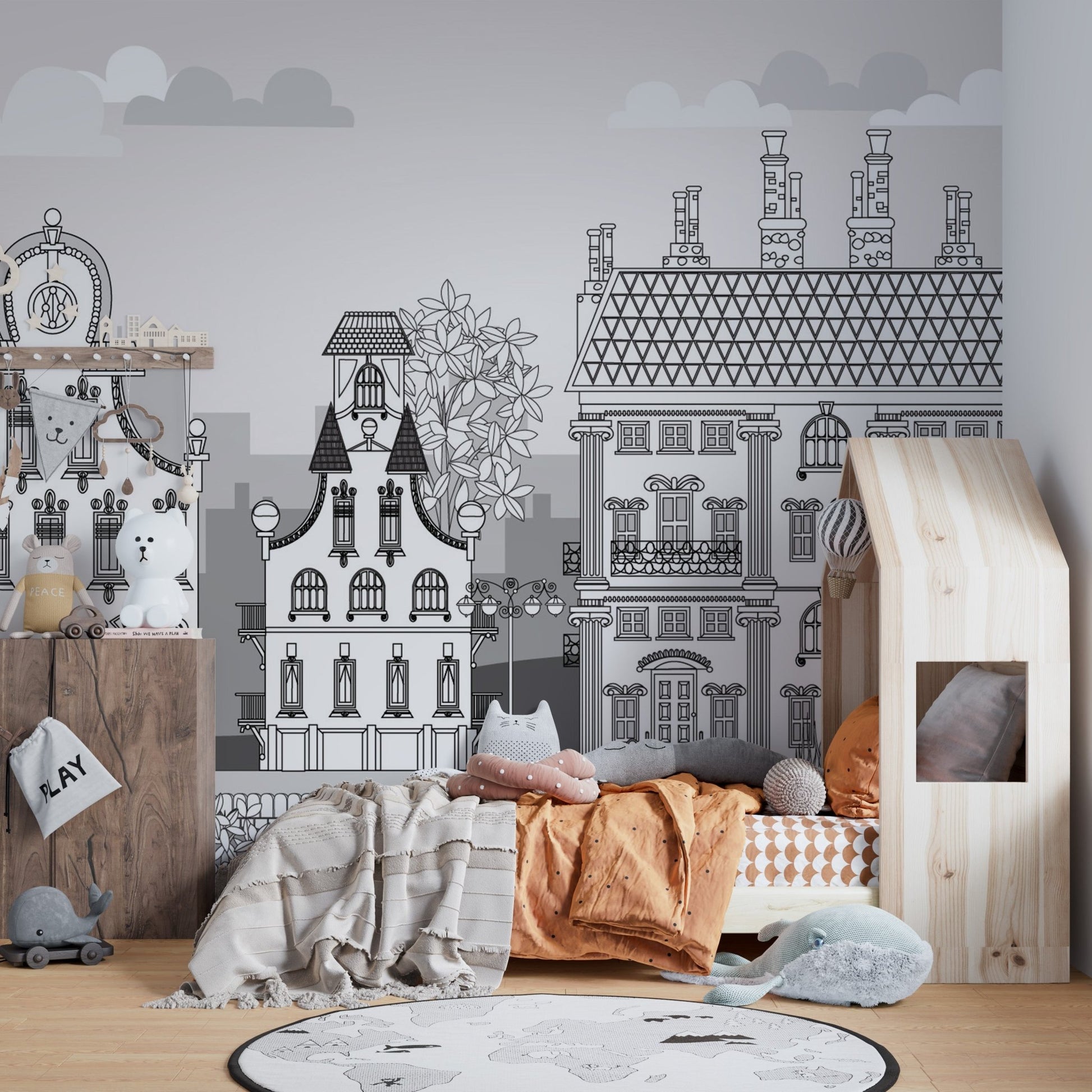 Black and white town sketch wall mural in a toddler bedroom with a house bed.