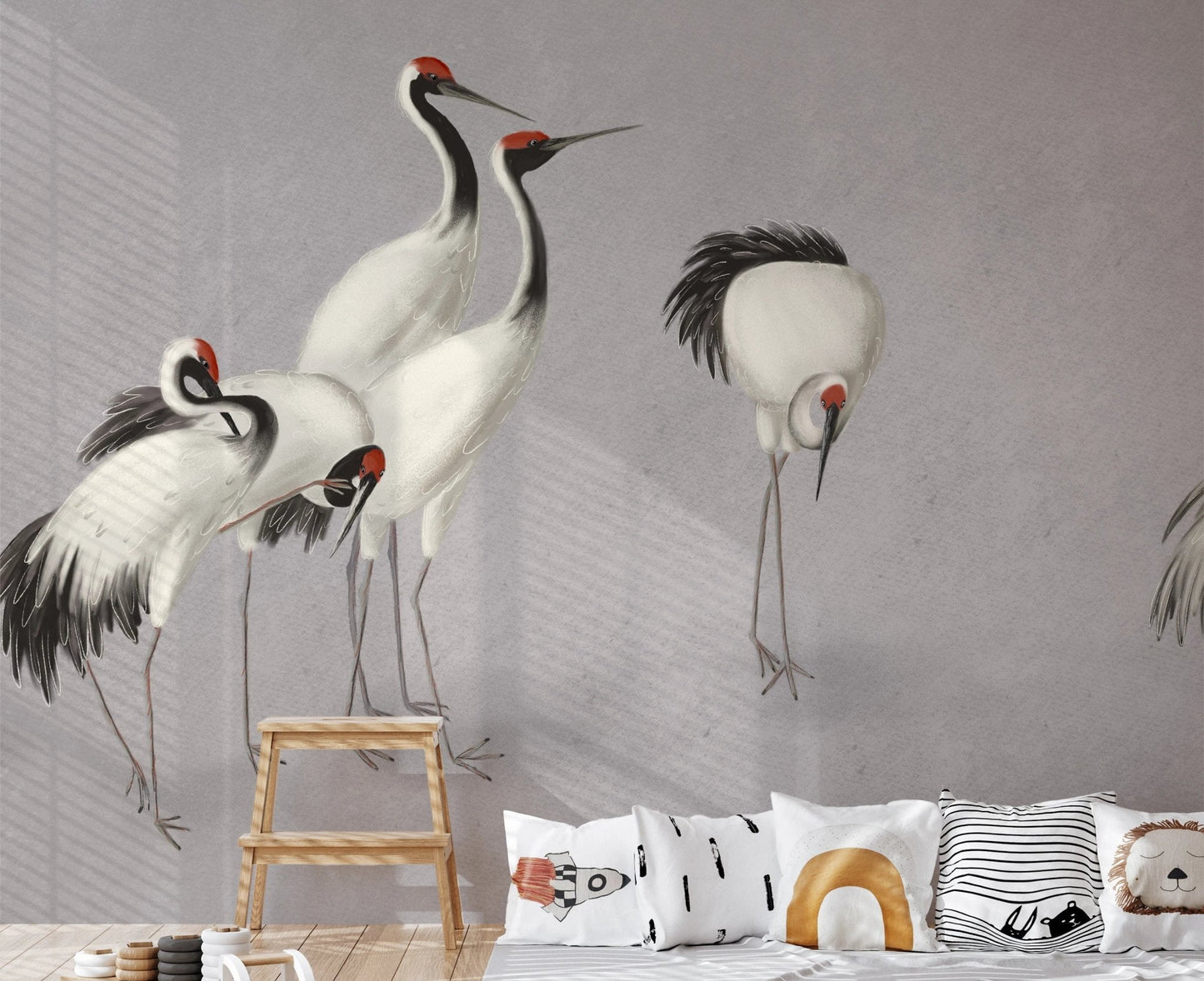 Playroom wall mural with crane bird illustrations and a wooden step stool.