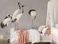White crane bird wall mural behind a child’s bed with pink and white linens.