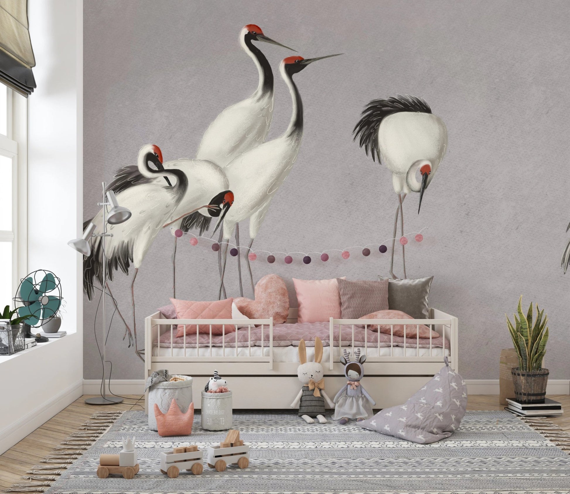 Daybed in a nursery decorated with a grey crane bird-themed wall mural.