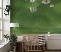 Gradient green mural adding depth and tranquility to nursery wall.
