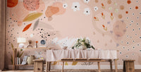 Dining table setting with a light pink abstract floral art wall mural.