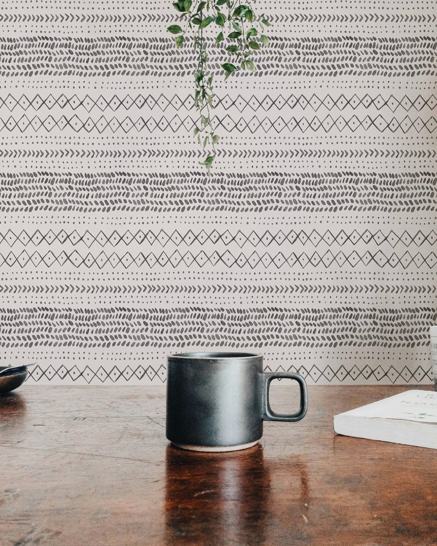Desk view with coffee mug and grey watercolor pattern wall mural.