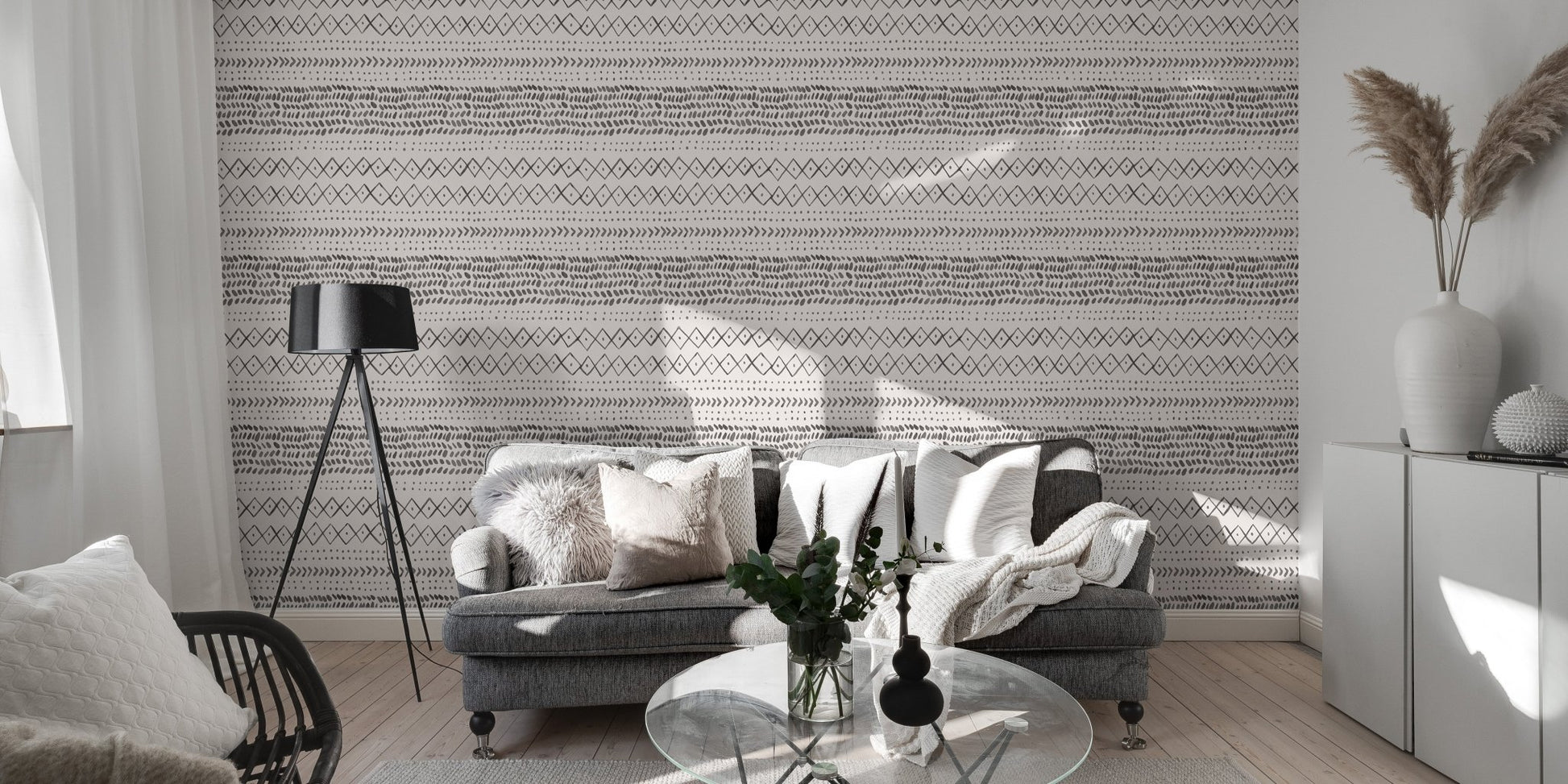 Living room with grey sofa and horizontal ethnic pattern wall mural.