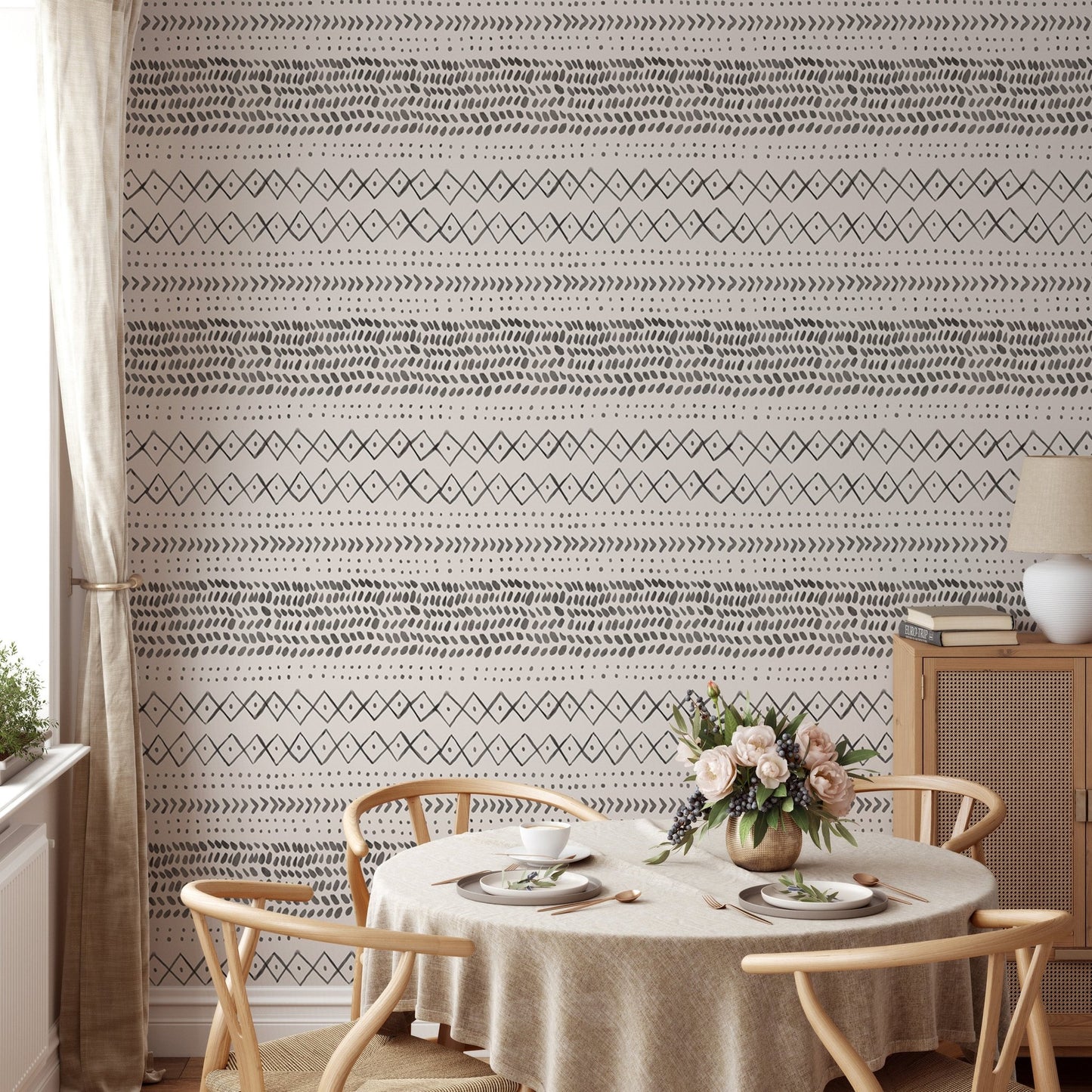 Dining area with circular table featuring ethnic boho pattern wall mural in grey.