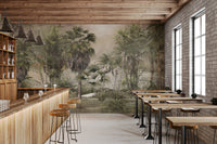 Commercial cafe interior featuring misty green rainforest tree wall mural.