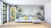 Grey palm tree wall mural in a white living room with a large sectional sofa.