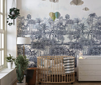 Tropical Forest Blue Wall mural in a nursery with a wooden crib and lamp.