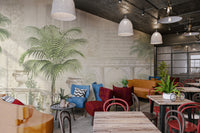 Large green palm fronds and stone urns wall mural for cafe dining area.