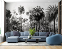 Lounge area with a blue L-shaped sofa and monochrome forest wall mural.