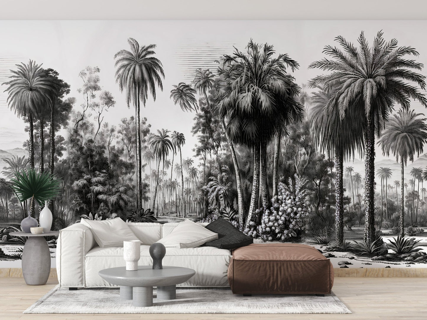 Living room with a white sofa and brown ottoman near a tropical forest wall mural.