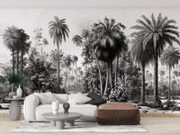 Living room with a white sofa and brown ottoman near a tropical forest wall mural.