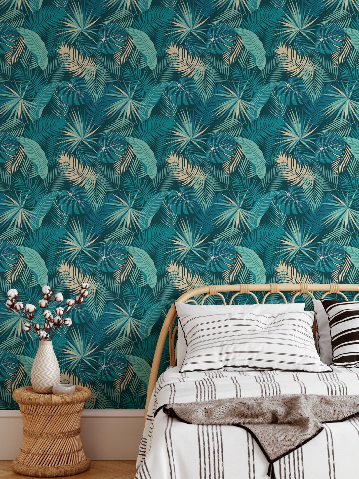 Teal and gold botanical leaves wallpaper in modern bedroom behind white bedding