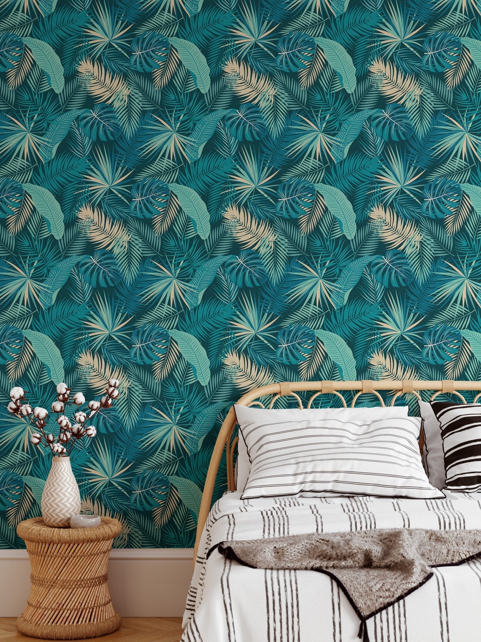 Teal and gold botanical leaves wallpaper in modern bedroom behind white bedding