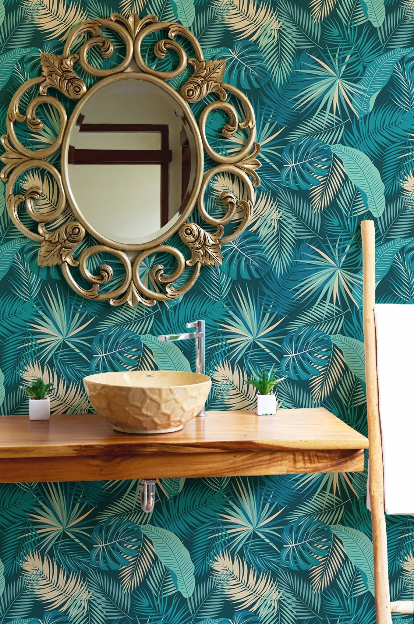 Turquoise palm leaf wallpaper in bathroom with gold mirror and wooden vanity