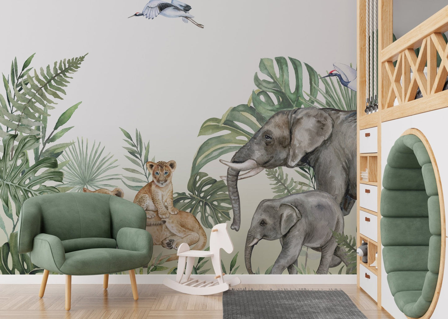 Nursery space featuring a green armchair and jungle animal wall mural.