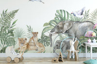 Nursery wall mural featuring grey elephants and lion cubs among green palm leaves.
