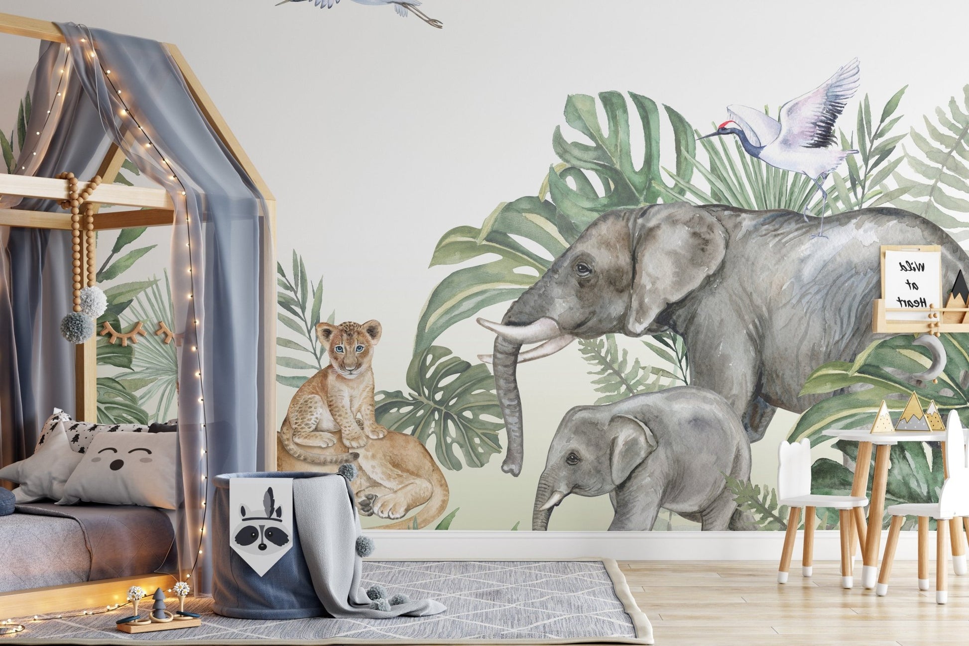 Childs bedroom with a house-shaped bed and elephant print wall mural.
