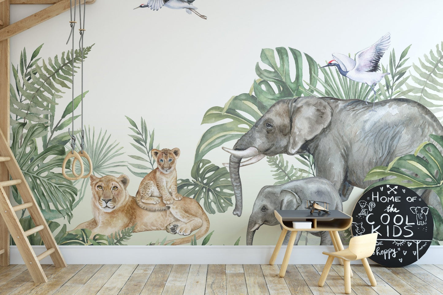 Jungle animal wall mural in a playroom with a swing and wooden stool.