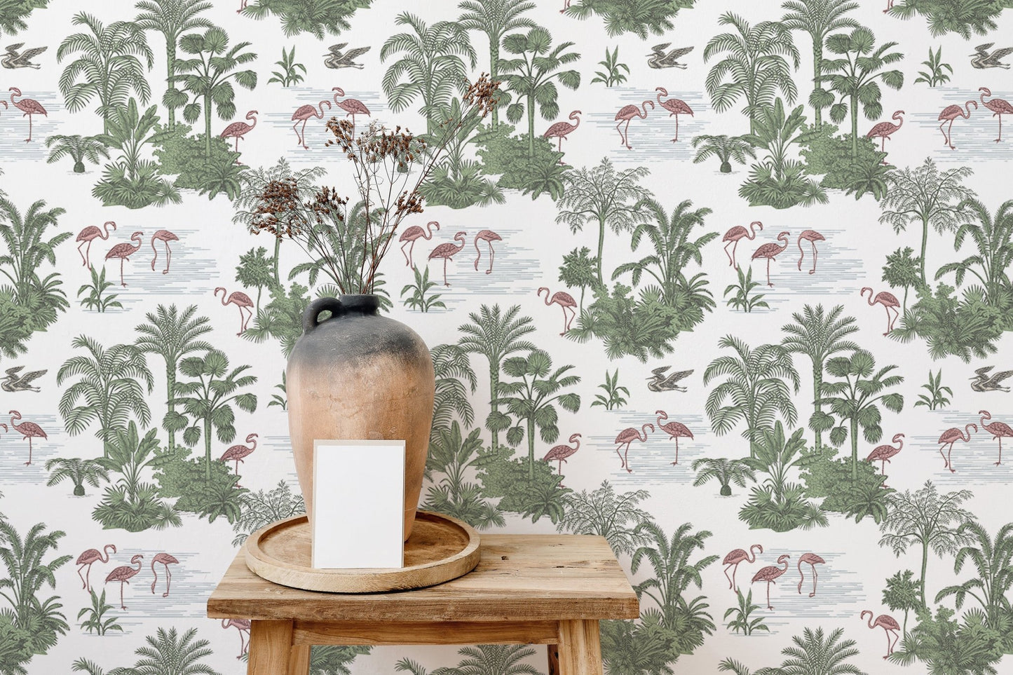 Flamingo and jungle plant wallpaper behind a wooden stool and ceramic vase.