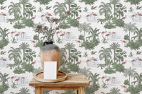 Flamingo and jungle plant wallpaper behind a wooden stool and ceramic vase.