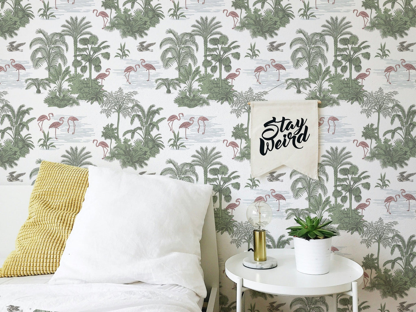 Tropical Palm Trees Flamingo Jungle Toile Wallpaper behind a bed with white pillows.