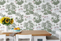 Jungle themed wallpaper in a dining room with wooden table and sunflowers.