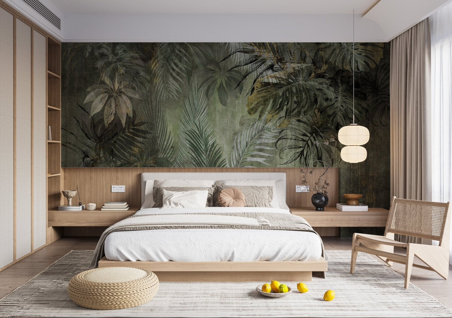 Palm tropical leaf wall mural in a bright bedroom with a low wooden bed frame.