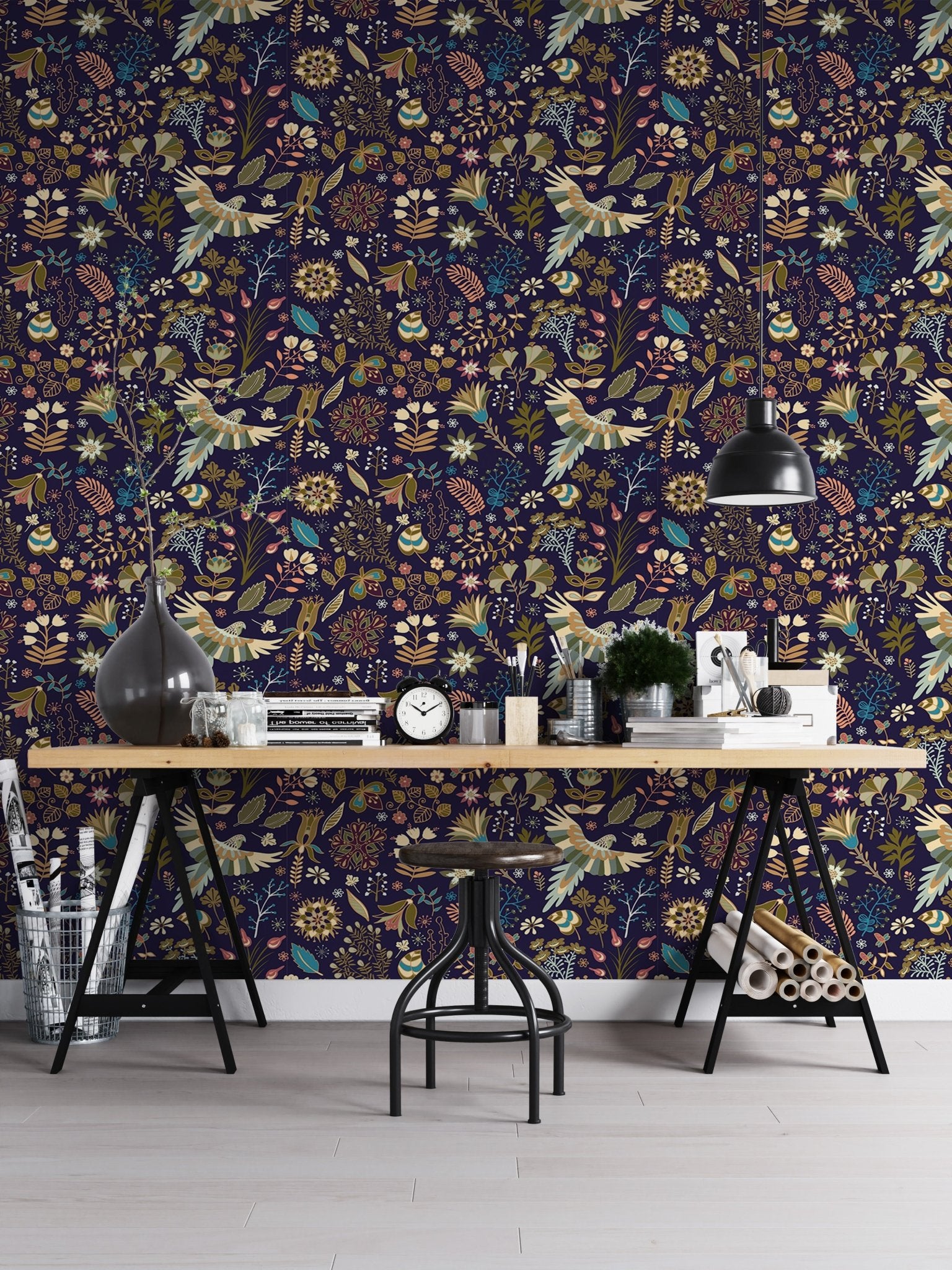 Dark blue flowers wallpaper with orange and yellow flora in a home office setup.