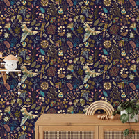 High-detailed botanical flower wallpaper behind a wood side table and green plant.