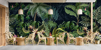 Restaurant seating area with large scale tropical jungle wall mural and pendant lighting.