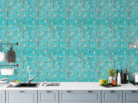 Turquoise floral wallpaper as a kitchen backsplash above white counters.