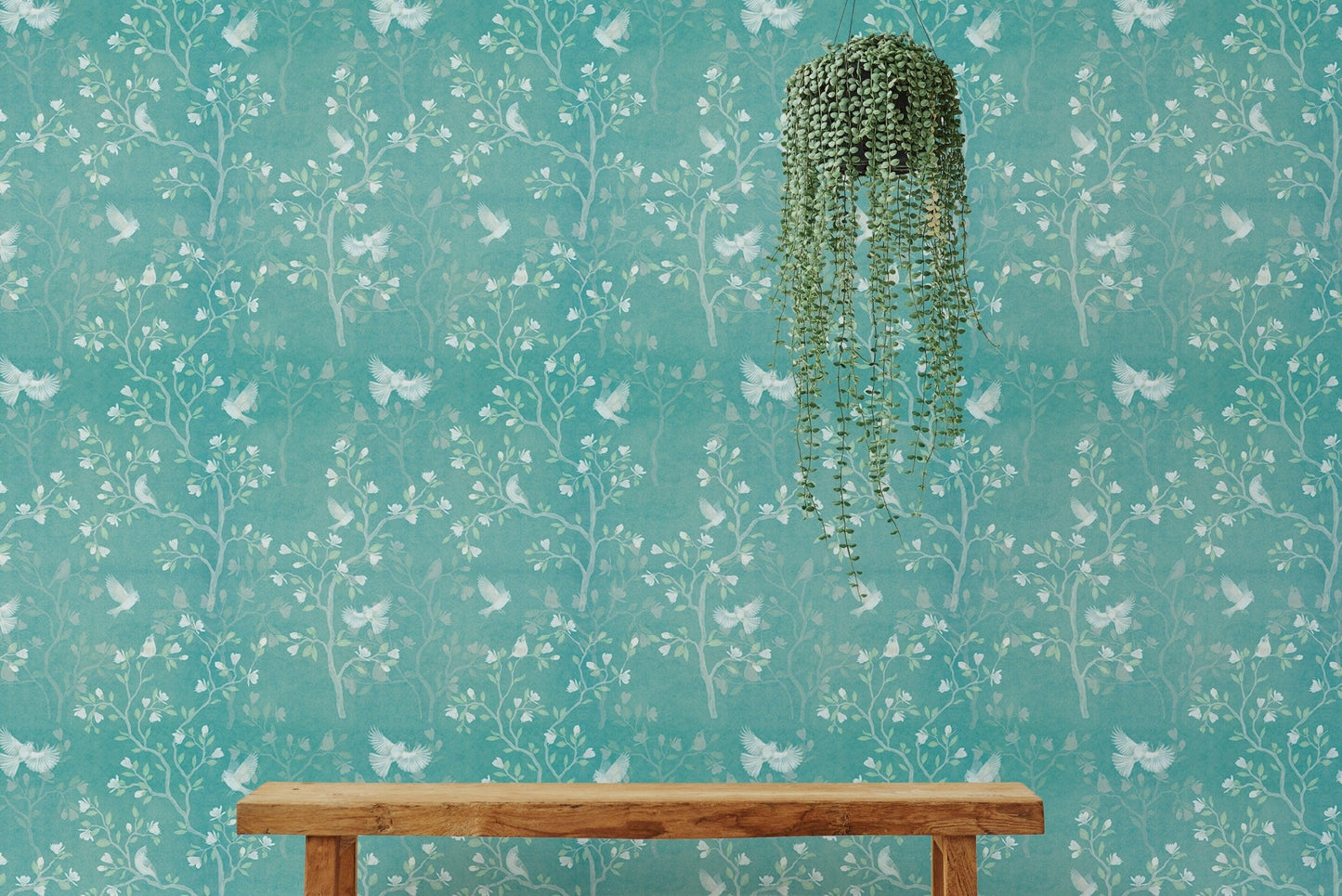 Magnolia tree wallpaper in a bright interior space with a wooden bench.
