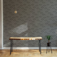 Twisted lines weaving wallpaper on an accent wall behind a narrow table