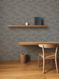 Geometric twisted lines wallpaper behind a study table and wooden chair