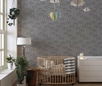 Black and white stripy wallpaper in a modern nursery with a wooden crib