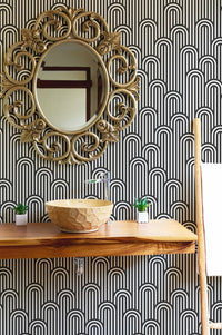Stripy weaving black and white wallpaper behind a bathroom vanity and mirror
